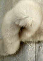 Halter-neck evening dress in silver-embroidered  grey silk with faux fur  trim